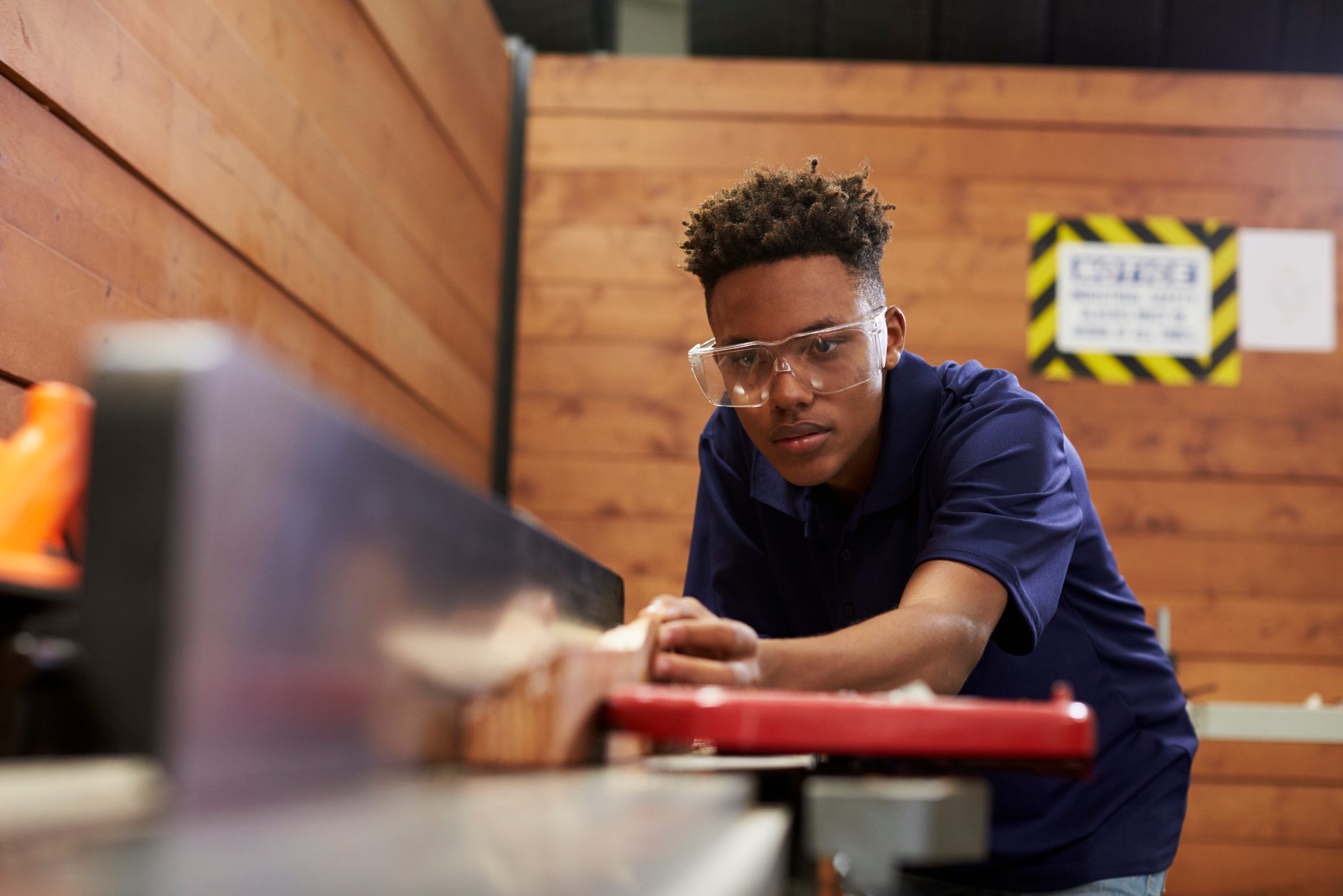 Carpenter Using Plane in Woodworking Woodshop